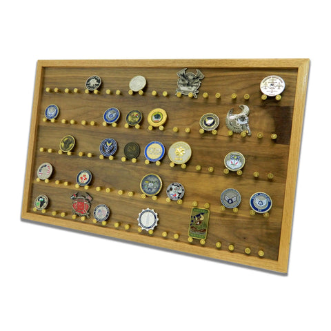 The ORIGINAL Brass Casing Challenge Coin Display - Large by Legacies of America Woodworking Company displays collectible challenge coins on multiple rows of pegs. The wooden rack is shown against a white background.
