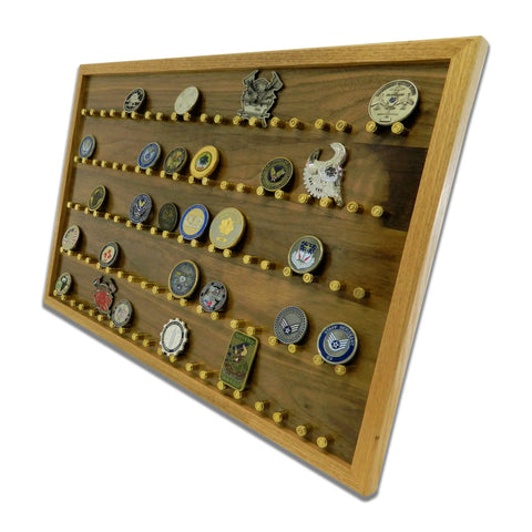 The ORIGINAL Brass Casing Challenge Coin Display – Large by Legacies of America Woodworking Company features multiple rows to showcase military challenge coins, each held on brass casing pegs to display unique designs and emblems.