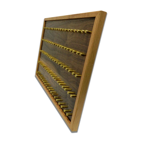 The ORIGINAL Brass Casing Challenge Coin Display - Large by Legacies of America Woodworking Company, American made with multiple rows of brass pegs, is ideal for organizing or displaying small items. Seen here from a side angle.