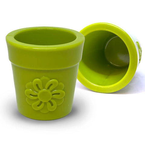 Two large green SodaPup Flower Pot treat dispensers, made from durable PUP-X rubber, feature raised flower designs. One stands upright and one lies on its side, both great enrichment toys for dogs on a white surface.