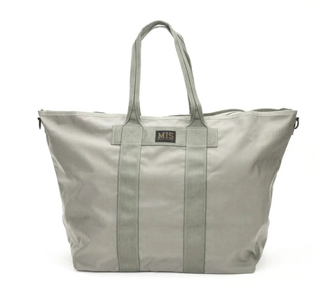 The MIS Super Tote Bag - Foliage is a large, 40L, water-resistant Cordura Nylon tote in light gray with two long handles, vertical straps, a small front rectangular logo patch, and a simple structured design.