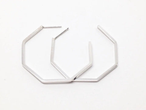 The SILVER GEO HOOPS | LARGE by Sarah Cecelia are sterling silver earrings with a sleek hexagonal design, shown on a white background—ideal for those who love minimalist geometric jewelry.