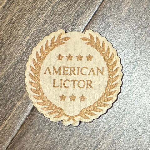 A Wood Sticker by American Lictor, featuring an engraved laurel wreath and stars around the brand name—laser etched on wood with a strong 3M adhesive backing, ideal for any brown surface.