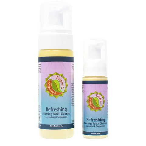 A large and a small bottle of Taspen’s Organics Refreshing Lavender Peppermint Foaming Facial Cleanser, both with colorful sun logo labels on blue backgrounds, offer natural skincare handcrafted in the USA for a refreshing clean.