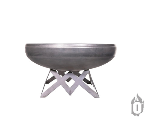 The Ohio Flame Liberty Fire Pit With Angled Base, made in the USA, features a modern round carbon steel bowl and geometric base. A flame logo appears at the bottom right. Includes lifetime warranty. Background is plain white.