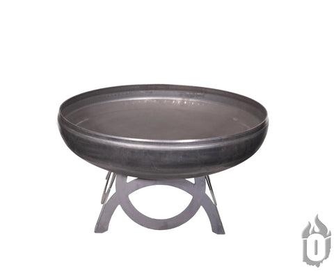 The Liberty Fire Pit With Curved Base by Ohio Flame, made in the USA, features a large round steel basin on a sturdy geometric stand with a smooth industrial finish. Shown on a white background with a small flame logo at the lower right.