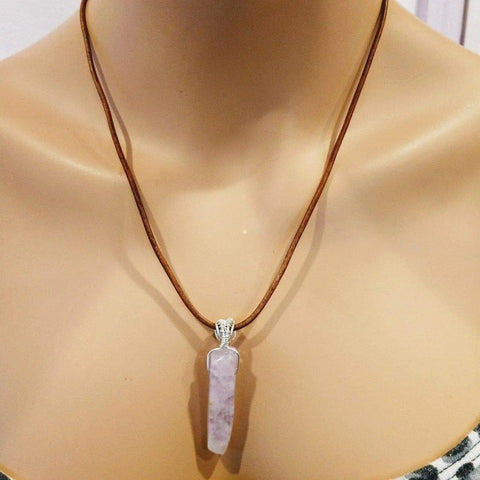 A mannequin showcases the Alexa Martha Designs Silver Wrapped Light Amethyst Gemstone Point Leather Necklace at the collarbone, highlighting its sterling silver wire-wrapped amethyst pendant on bare skin.