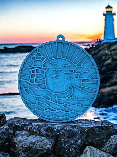 The Lighthouse EMat Enrichment Lick Mat With Suction Cups by SodaPup features a round, blue design with a lighthouse, waves, and seagulls—perfect for challenging your dogs mind while evoking serene seaside sunsets.