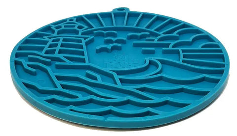 The SodaPup Lighthouse EMat Enrichment Lick Mat With Suction Cups is a blue silicone trivet with a raised lighthouse, birds, waves, and sun design that also serves as an engaging brain-challenging lick mat for dogs.