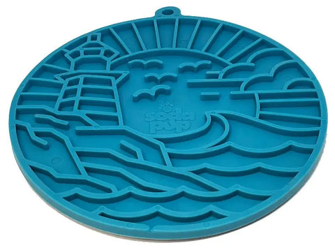 The SodaPup Lighthouse EMat Enrichment Lick Mat With Suction Cups is a round blue silicone mat featuring a raised lighthouse, ocean waves, birds, clouds, and sun—perfect for challenging your dogs mind.