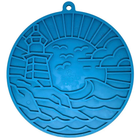 The SodaPup Lighthouse EMat Enrichment Lick Mat is a blue, round silicone mat with suction cups and a raised lighthouse, seagulls, clouds, and ocean waves design for enrichment activities.
