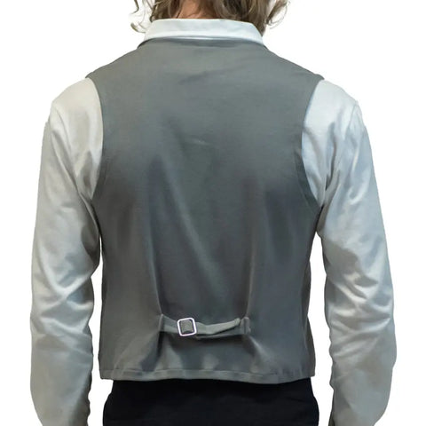 A person with wavy, shoulder-length hair is seen from the back wearing a white long-sleeve shirt and the Spiritex Vanderbilt Vest, a gray French Terry style with an adjustable buckle at the lower back. The background is plain white.