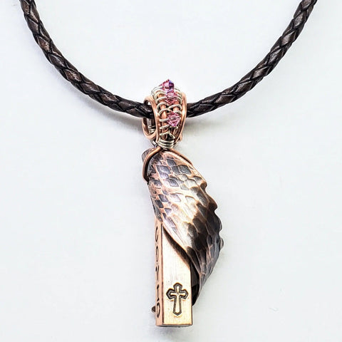 The Memorial Birthstone Angelwing Necklace-Limited Special Edition 2020-2024 by Alexa Martha Designs features a braided dark chain, bronze feather, cross LOVE charm, and pink stones—an ideal keepsake to celebrate your childs birth.