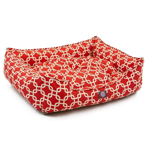 The Majestic Pet Links Contemporary Lounge Bed is a red rectangular dog bed with white geometric patterns, padded sides, and a cushioned fiberfill base, shown on a white background.