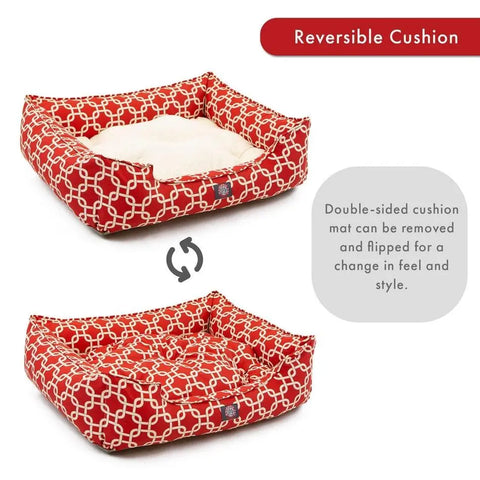 The Majestic Pet Links Contemporary Lounge Bed is a red rectangular dog bed with a white geometric pattern and a removable, reversible cream cushion for versatile comfort and style. Circular arrow icon shows the reversible feature.