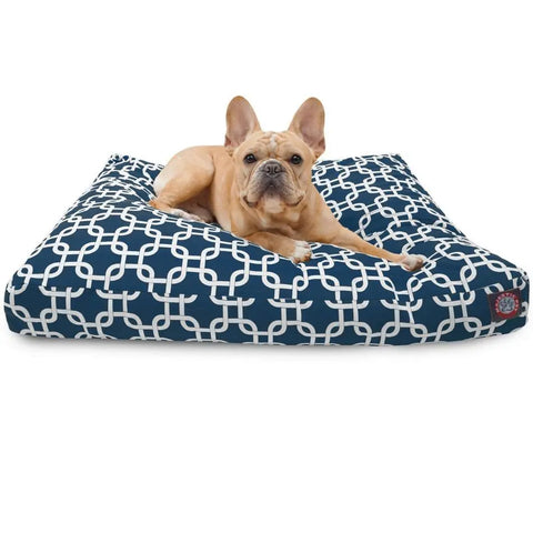 A light brown French Bulldog rests on the Majestic Pet Links Rectangle Dog Bed, featuring a navy blue and white geometric pattern. Its washable cover and premium polyester fill ensure comfort and easy care.