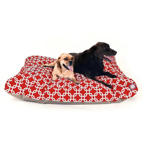 Two dogs, one tan and one black, lounge on the Majestic Pet Links Rectangle Dog Bed with a white geometric pattern, premium polyester fiber fill, and a washable cover. Both face left comfortably with their tongues out.