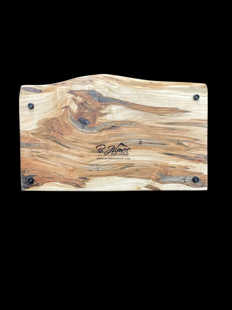 The Ambrosia Live Edge Serving Tray by B. James Design & Woodwork features a rectangular wooden design, wavy top edge, visible natural grain, four black corner screws, and a center logo reading B. James and www.bjamesdesigns.com.