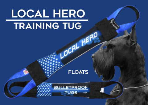 A blue and black Local Hero Fire Hose Training Tug by Bulletproof Pet Products Inc is shown with a black Schnauzer in the background and the word FLOATS on a blue background, highlighting this durable dog tugs quality.