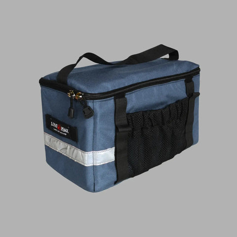 The Lone Peak Basic Rack Pack by Lone Peak Packs is a blue and black insulated bike bag with a black handle, front mesh pocket, side loops, reflective strip, and zipper closure, shown on a plain gray background.