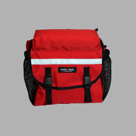 The Lone Peak Recumbent Backpack Seat Pack by Lone Peak Packs is a red, water-resistant bag with a front flap, two black buckles, black mesh side pockets, and a white stripe above the Lone Peak label on a plain gray background.