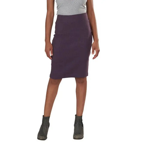 A person in a gray sleeveless top, the Long Andy Skirt by Spiritex | Sustainable Apparel in dark purple organic cotton, and gray ankle boots stands against a white background—ideal for stylish office wear.