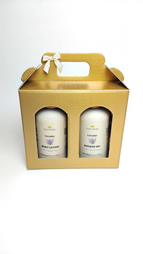 A gold gift box with a handle and bow presents Forev'Herbs Lotion / Shower Gel Gift Set in “Lavender.” Both products are visible through clear windows, arranged against a plain white backdrop.