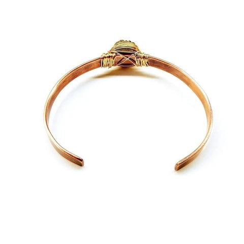 The LOVE Stamped Gold Wire Wrapped Purple Druzy Copper Cuff by Alexa Martha Designs showcases a handmade copper cuff with gold wire wrapping and a central round purple druzy agate, displayed on a white background.