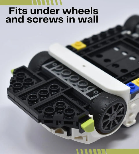 Close-up of Chatelet Manufacturing’s Low Profile Collectible Car Display Wall Mount (white), compatible with Lego car models—shows how it holds cars by the wheels for a sleek, secure display. Made in USA.