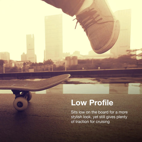 A close-up of a skateboarder’s feet mid-air over a board with a city backdrop. Text reads: Chatelet Manufacturing Low Profile Foot Stop—boost traction, balance, and control for longboards or e-skates on hills and turns.