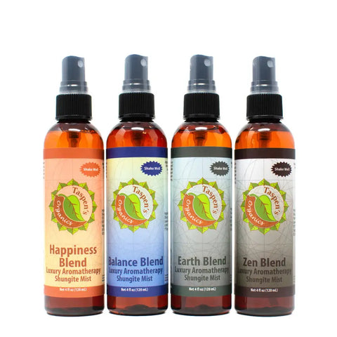 Four amber bottles labeled Happiness, Balance, Earth, and Zen stand side by side—each a Taspen’s Organics Luxury Aromatherapy Shungite Mist with organic essential oils and colorful, distinct labels.