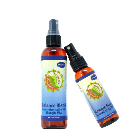 Two amber bottles of Taspen’s Organics Luxury Aromatherapy Shungite Mists—one upright, one leaning—with blue and green labels. The larger bottle features an energy-balancing formula made from organic essential oils.
