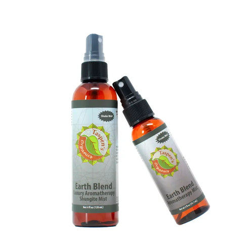 Two amber spray bottles of Luxury Aromatherapy Shungite Mists by Taspens Organics feature gray labels, black spray tops, and an energy balancing blend of organic essential oils. One bottle stands upright; the other leans diagonally.