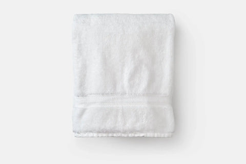 The American Blossom Linens Bath Towel Made of Luxury USA Cotton features a simple textured band and ultra-soft premium cotton, shown neatly folded on a plain white background.
