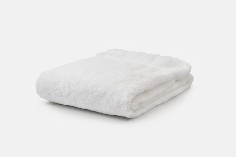 The Bath Towel Made of Luxury USA Cotton by American Blossom Linens, crafted for exceptional softness, is neatly folded and set against a white background.