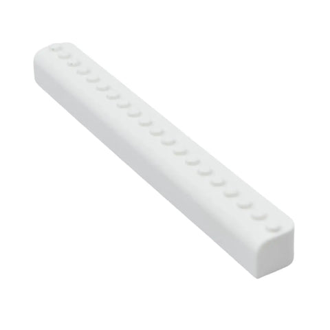 A white, rectangular Collectibles Display Fridge Magnet by Chatelet Manufacturing, compatible with Lego Minifigures and perfect for displaying figurines on any fridge or metal surface, is shown at an angle on a plain white background.