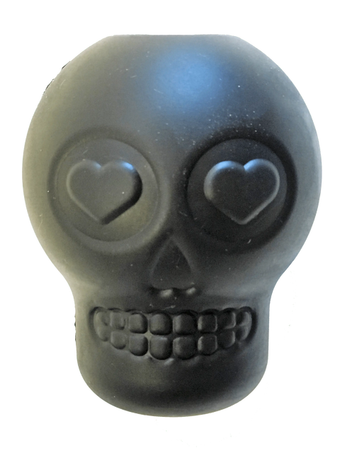 The SodaPup Magnum Sugar Skull EDispenser is a black ultra-durable chew toy and treat dispenser featuring heart-shaped eye sockets, a wide grin, and a smooth, slightly shiny surface.