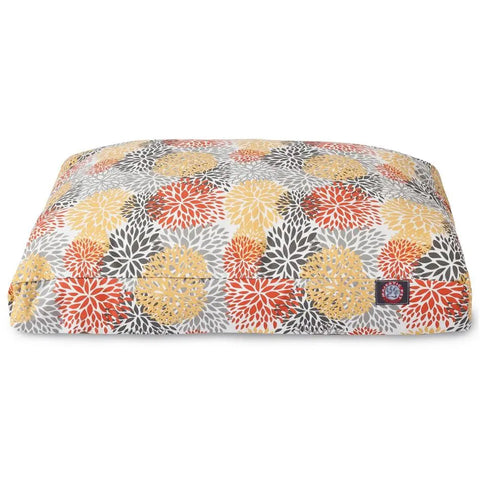 The Majestic Pet Blooms Rectangle Dog Bed Citrus features a yellow, orange, gray, and white floral pattern with a small logo tag sewn on the bottom right corner.