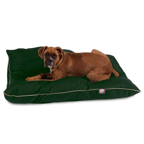 A brown dog lies on a large Majestic Pet Poly/Cotton Super Value Dog Bed in dark green with light piping, featuring a small red and white tag. This hypoallergenic bed is fully machine washable for easy care.