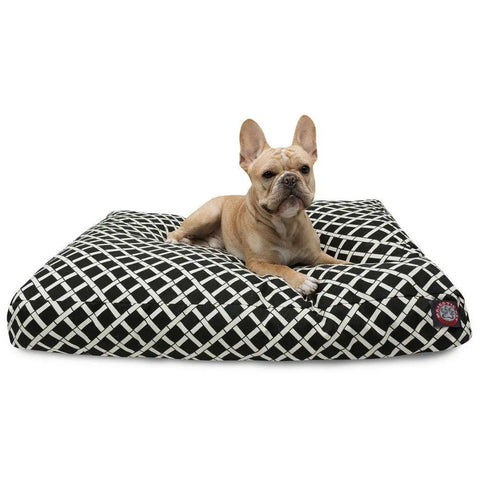 A light brown French Bulldog lies alert on a Majestic Pet Bamboo Rectangle Dog Bed with a black and white crisscross pattern and enjoys the comfort of its washable, removable cover.