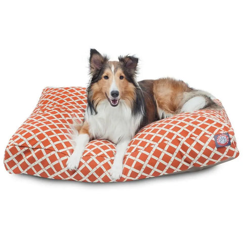 A brown and white dog with pointy ears lies on a Majestic Pet Bamboo Rectangle Dog Bed, looking forward with its mouth slightly open.