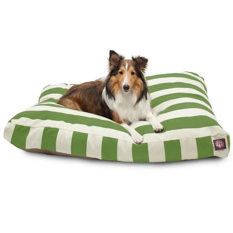 A Shetland Sheepdog rests on a Majestic Pet Vertical Stripe Memory Foam Dog Bed with a washable, removable cover, gazing at the camera.