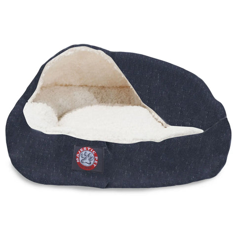 The Wales Canopy Cat Bed by Majestic Pet features a cozy dark blue exterior, cream Sherpa lining, and hooded cover. A red and blue Majestic Pet logo patch decorates the front. The bed is machine washable for easy care.