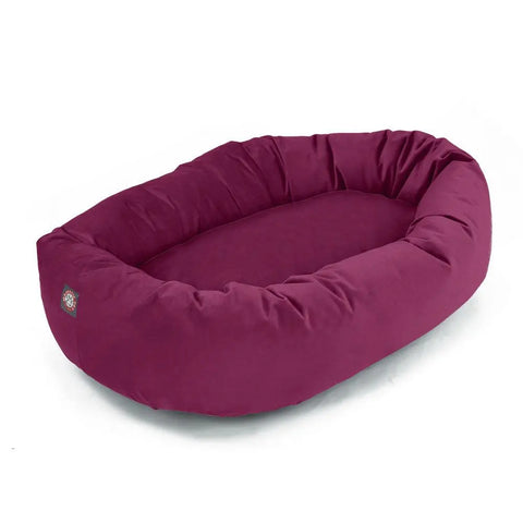The Majestic Pet Poly/Cotton Bagel Dog Bed is a maroon, oval bed with raised sides, a soft cushioned base, and spine support for comfort and healthy rest.