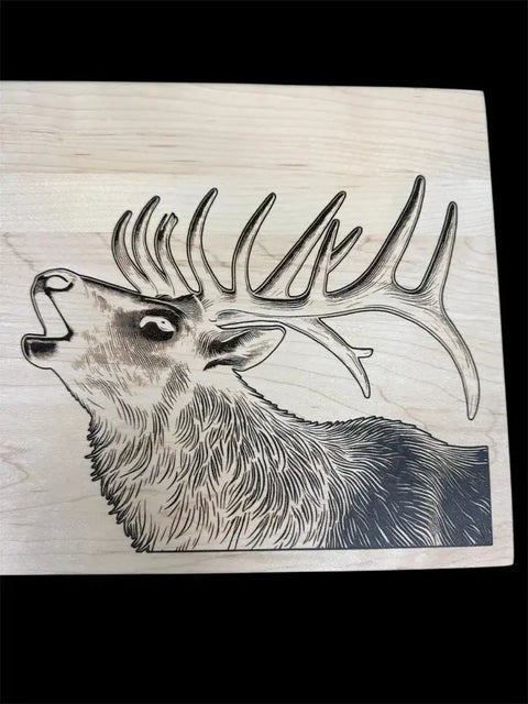 The Elk Epoxy Inlay Board by B. James Design & Woodwork features a detailed black and white elk engraving with large antlers on solid maple, ideal for an epoxy inlay to enhance its bold design.