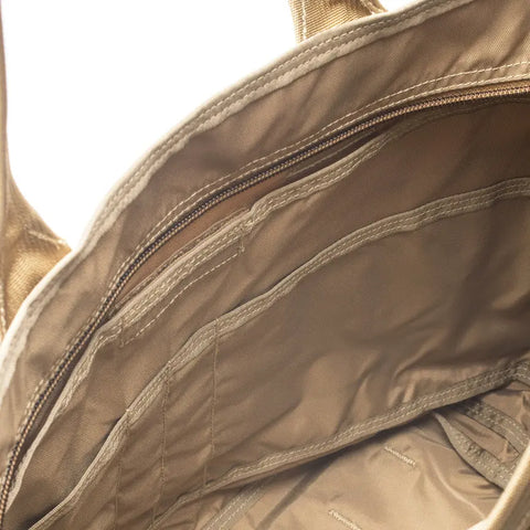 Close-up of the MIS Tote Bag - MarPat Desert interior, featuring a heavy-duty zipper pocket and multiple open compartments stitched into the water-resistant tan Cordura Nylon lining.
