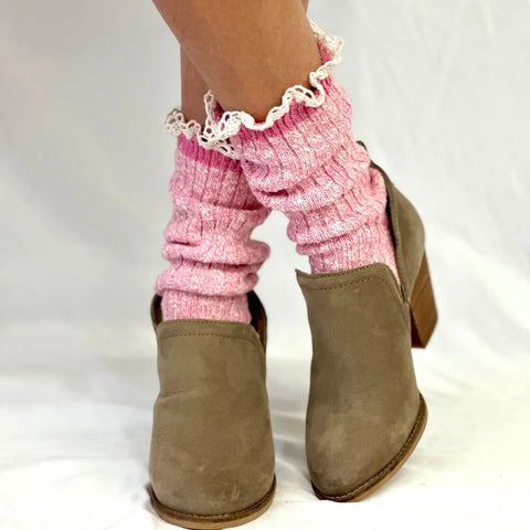 A pair of feet in light brown heels and Catherine Cole MARLED Cotton Short Lace Boot Socks - Pink stands on a white surface against a white background.