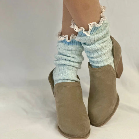 A person wearing Catherine Cole MARLED Cotton Short Lace Boot Socks in Carolina Blue and light brown ankle boots, standing against a plain white background.