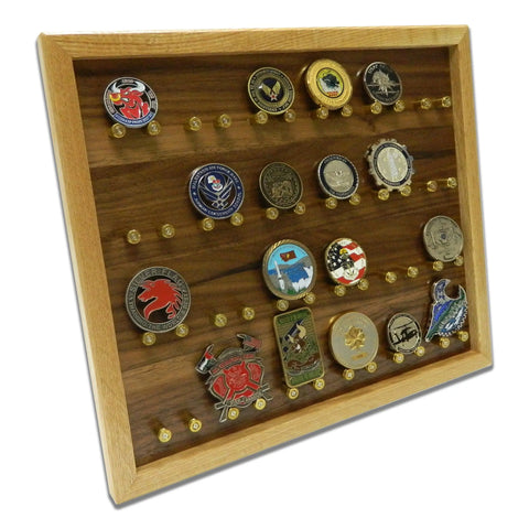 The ORIGINAL Brass Casing Challenge Coin Display - Medium by Legacies of America Woodworking Company is American made, with a glass front and rows of individual pegs to neatly showcase your cherished challenge coin collection.