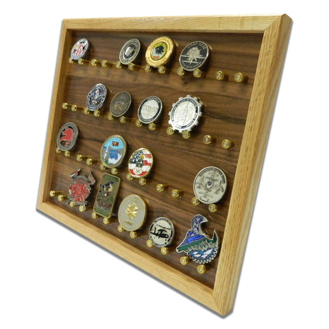 The ORIGINAL Brass Casing Challenge Coin Display - Medium by Legacies of America Woodworking Company securely holds multiple collectible coins on brass-pegged rows behind a clear acrylic front, showcasing various designs and emblems.